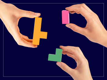 Hand joining blocks together representing community